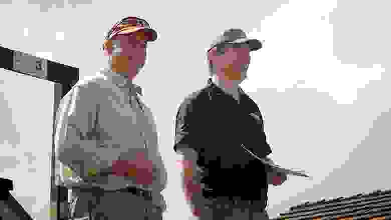 Two Men in Baseball Caps Smiling